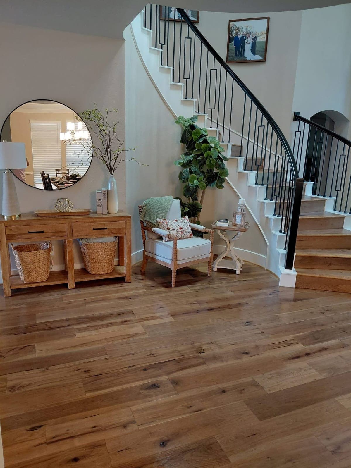 Entryway with a curved staircase and freshly cleaned wood floor