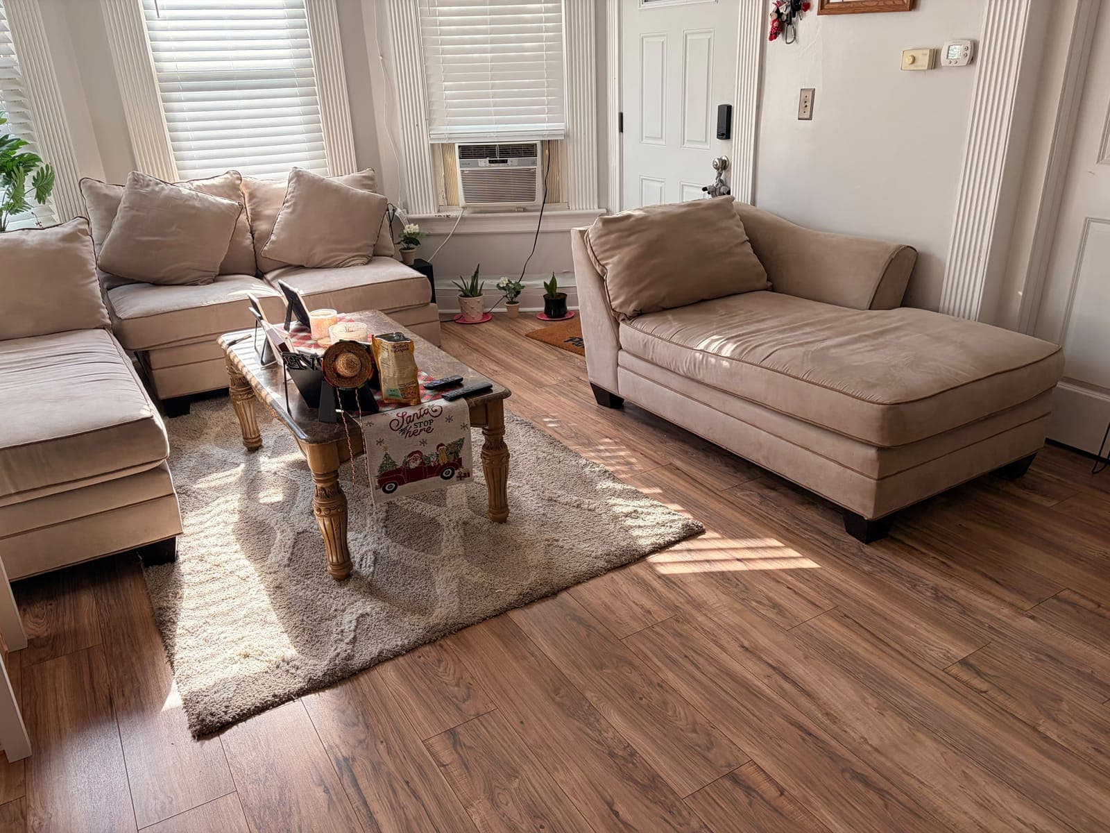 Living room with light sofas and a clean wood floor